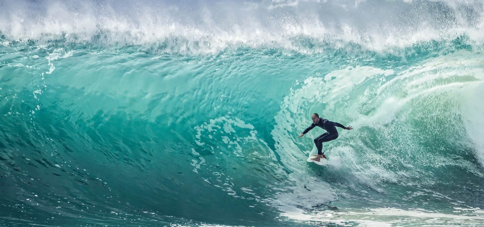 Surfer riding huge wave